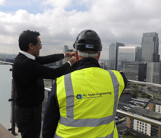 Man on Balcony Over Canary Wharf